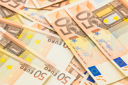 Pile of 50 euro money banknotes, business background.