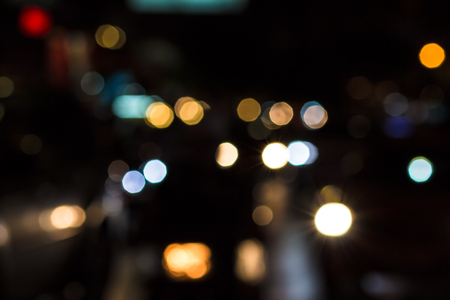 Abstract bokeh light background of city night with vignette vintage color tone tuned.Beautiful Christmas background.の写真素材