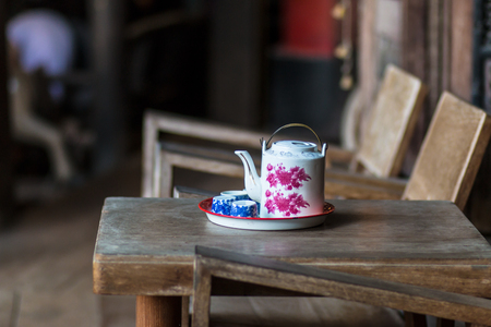 Vintage Chinese teapot and tea cups on wooden table,Chinese Tea set with small tea cups.の写真素材