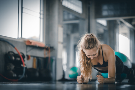 Portrait young attractive healthy woman body curve fitness doing push ups exercises workout with ball in gym. People beauty perfect body slim fitness girl. Freedom happy and relax lifestyle healthcare conceptの写真素材