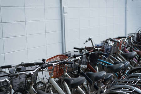 Bicycles parking near the white wall buildingの写真素材