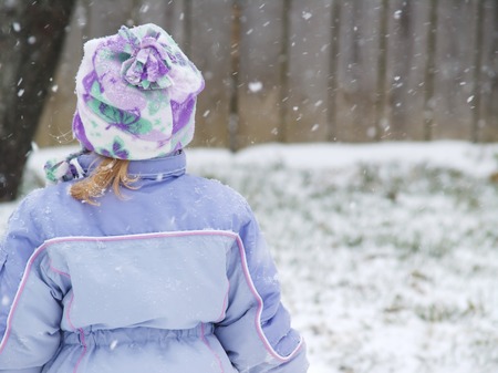 Little Girl Playing in Snowの写真素材