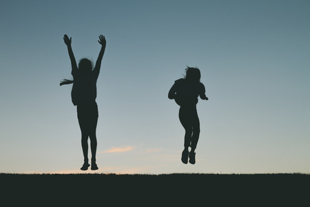 Little girl silhouette jumpingの写真素材
