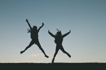 Little girl silhouette jumpingの写真素材