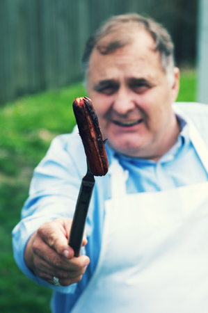 Adult Male Grilling Foodの写真素材