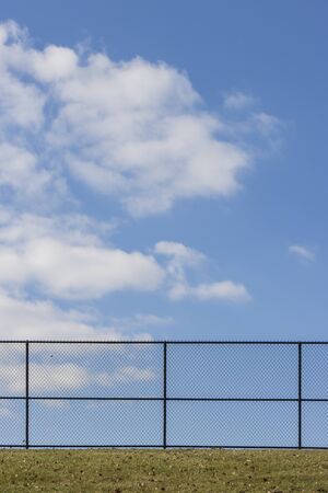 Empty Fence Blue Skyの写真素材