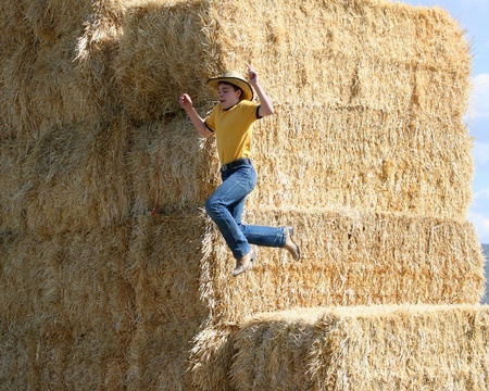 Cowboy jumps off straw stackの写真素材