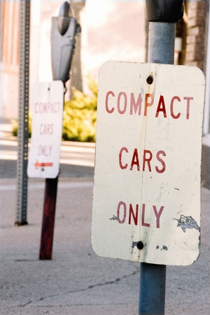 Foto de Compact cars only parking sign on urban street  - Imagen libre de derechos