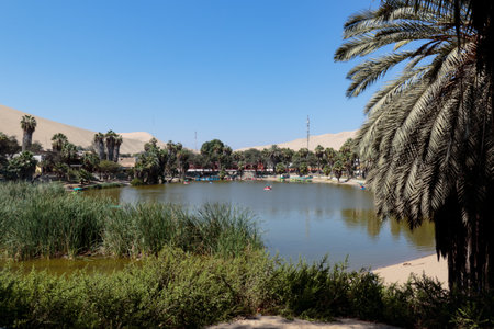 An oasis in the middle of the desert, so is this small lagoon called Huacachina in Ica - Peru; It is a popular tourist destination for its unusual scenic beauty.の写真素材