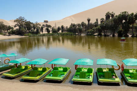 An oasis in the middle of the desert, so is this small lagoon called Huacachina in Ica - Peru; It is a popular tourist destination for its unusual scenic beauty.の写真素材