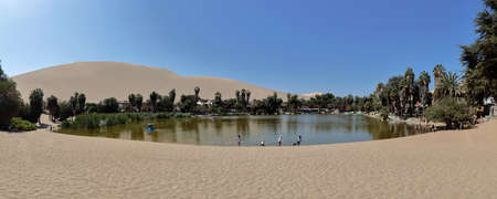 Huacachina, Ica. August 20, 2021 - Popular Huacachina lagoon frequented by many tourists who come to visit this unique oasis in the middle of the desert. Ica-Peruのeditorial素材