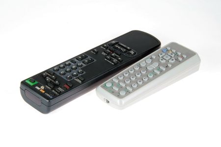 two black white remote controls placed side by side