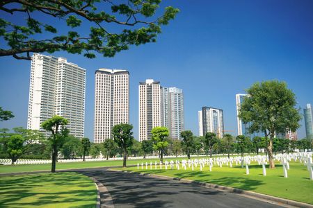 modern military cemetery with tall buildings as backgroundの写真素材