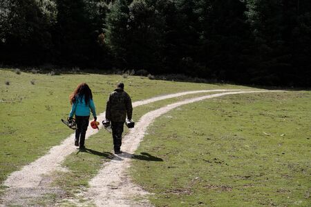Lumberjack couple walking through the woods