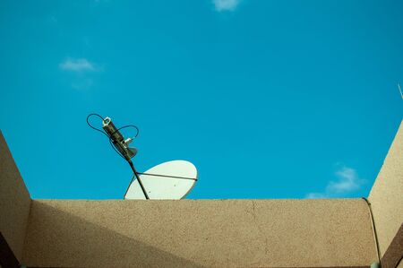 Parabolic television antenna outside the houseの写真素材