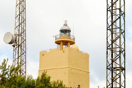 Small yellow tower with lighthouseの写真素材