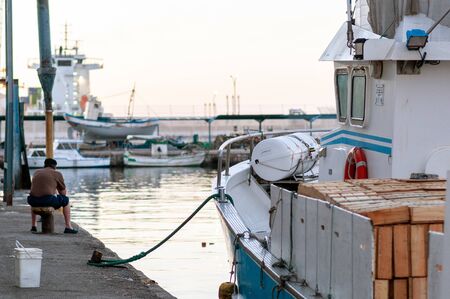 Berth in fishing port with boatsの写真素材