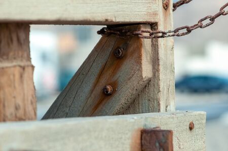 Wood plank with rusty metal chainの写真素材