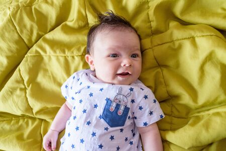 Little boy in yellow blanketの写真素材