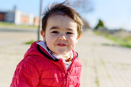 Little boy in red coatの写真素材