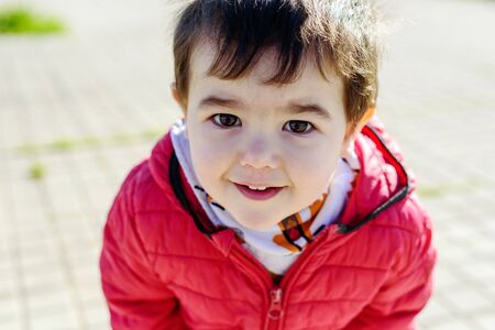 Little boy in red coatの写真素材