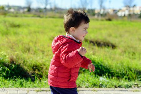 Little boy in red coatの写真素材