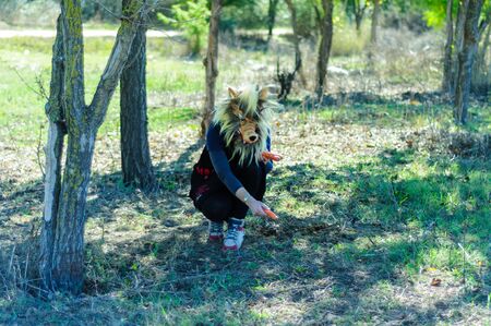 Woman in wolf mask and black dressの写真素材