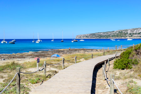 Natural wooden walkway on sandy beach on the way to the seaの写真素材