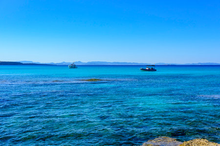 Seascape with beach shore and boats on the waterの写真素材