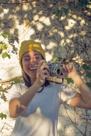 Girl taking pictures in the gardenの写真素材