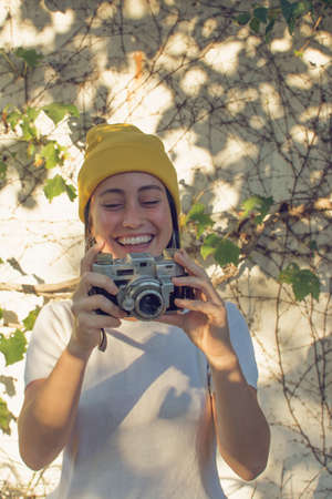 Girl taking pictures in the gardenの写真素材