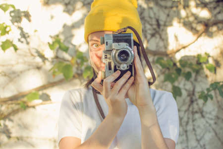 Girl taking pictures in the gardenの写真素材