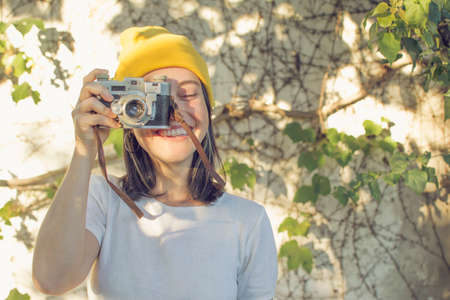 Girl taking pictures in the gardenの写真素材