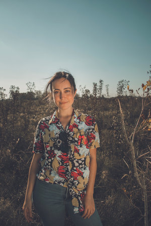 Young free woman in the field full of colors