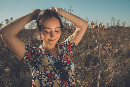 Young free woman in the field full of colorsの写真素材