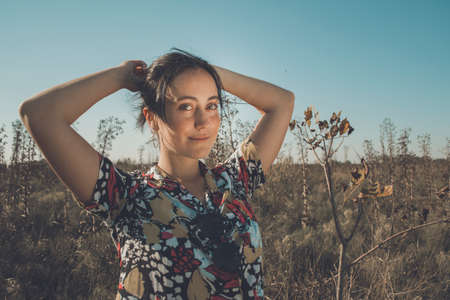 Young free woman in the field full of colorsの写真素材