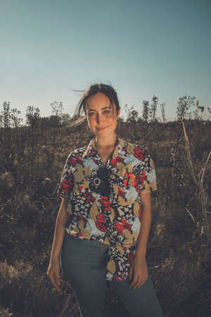 Young free woman in the field full of colorsの写真素材