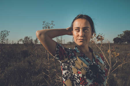 Young free woman in the field full of colorsの写真素材