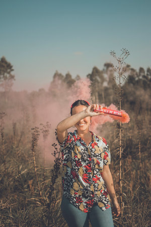 Young free woman in the field full of colorsの写真素材