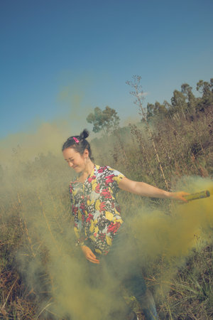 Young free woman in the field full of colorsの写真素材