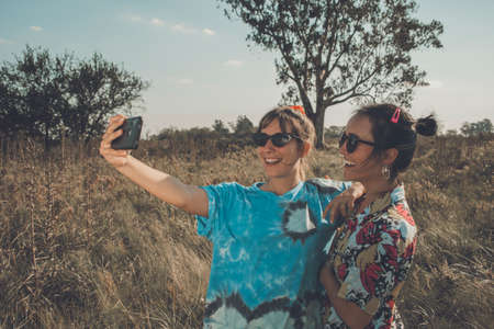 Happy free girls in the field full of colorsの写真素材