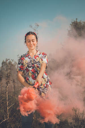 Young free woman in the field full of colorsの写真素材