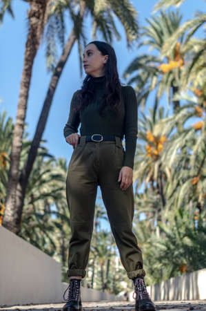 Model smiling at a photo shoot in the park, in nature, with the sunの写真素材