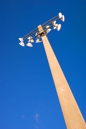 Stadium lights against blue sky.