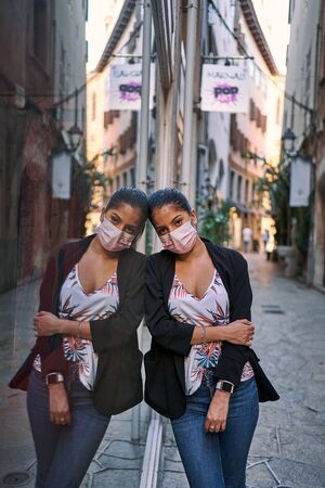 COVID-19 Pandemic Coronavirus Woman in city street wearing face mask protective for spreading of...