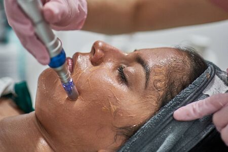 Beauty face skin care. Woman with cosmetic facial mask.