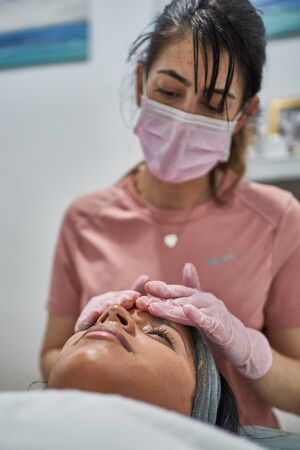 Beauty face skin care. Woman with cosmetic facial mask.の写真素材