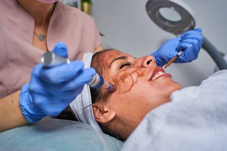 Beauty face skin care. Woman with cosmetic facial mask. Selective focus.の写真素材
