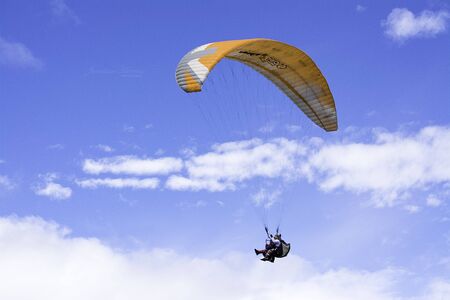 People practicing paragliding as an extreme sport on vacation