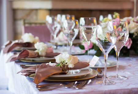 glasses of wine and plates in an elegant and formal banquet of a wedding. Thanksgiving dinner, elegant meeting with a glass of wine.の写真素材